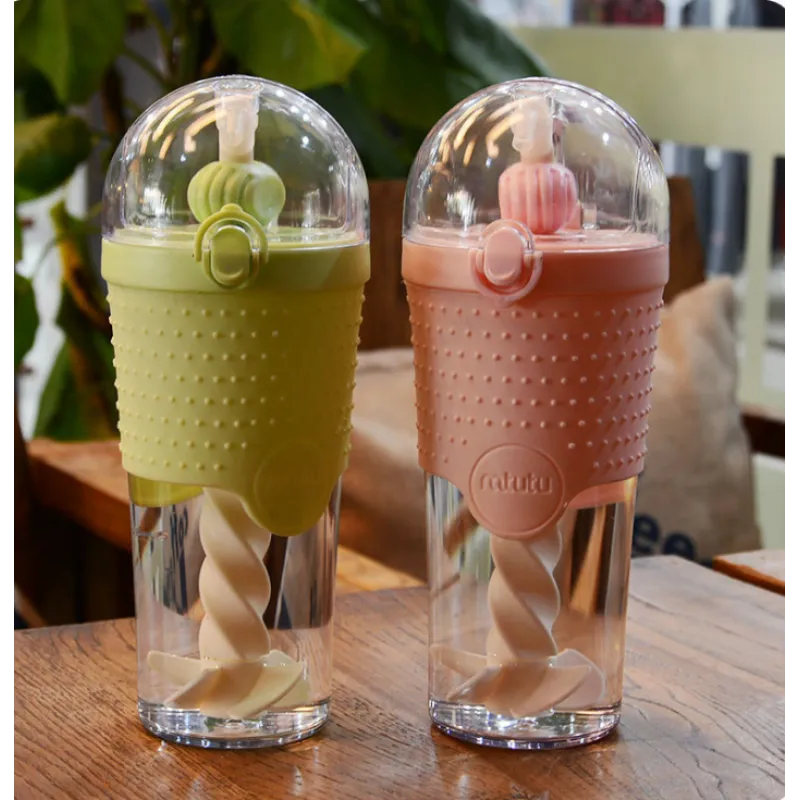 A close-up of a colorful plastic water bottle with a knitted cover and a lid.