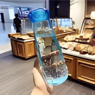 "Transparent crystal glass water bottle with infuser compartments for fruit and herbal drinks, designed for healthy hydration"